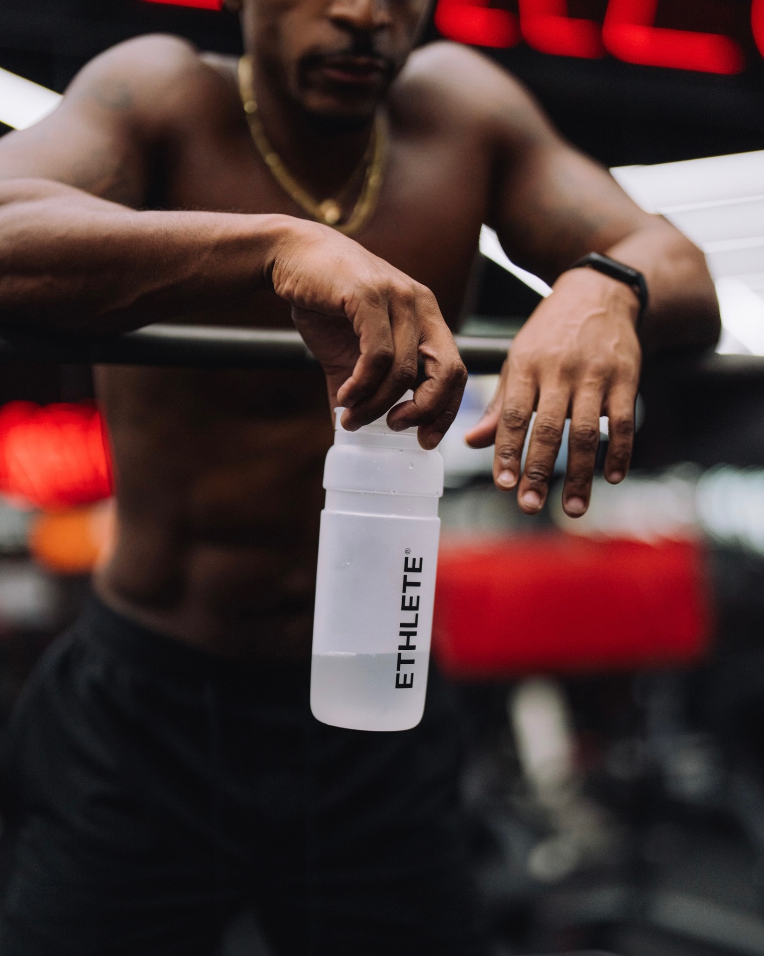 Close-up of the ETHLETE bottle resting on a bench